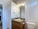Bathroom features a vanity with granite top, a mirror, and a toilet at 12637 Tyler Run Ave, Odessa, FL 33556
