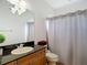 Bathroom featuring a vanity with granite countertops, a shower with a curtain, and neutral walls at 12637 Tyler Run Ave, Odessa, FL 33556