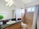 Bathroom features a tiled shower, granite counters, and a vanity with wood cabinets at 12637 Tyler Run Ave, Odessa, FL 33556