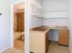 Bathroom and built-in desk nook; featuring a shower/tub combo, with vanity space with storage at 12637 Tyler Run Ave, Odessa, FL 33556