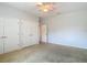 Bedroom featuring carpeting, two double door closets, a window, and a fan on the ceiling at 12637 Tyler Run Ave, Odessa, FL 33556