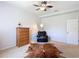 Bedroom featuring an armchair, dresser, and unique ceiling fan, creating a comfortable atmosphere at 12637 Tyler Run Ave, Odessa, FL 33556