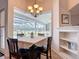 Cozy dining area with chandelier lighting and views of the screened lanai and backyard at 12637 Tyler Run Ave, Odessa, FL 33556