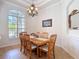 A formal dining room features crown molding and large windows for lots of natural light at 12637 Tyler Run Ave, Odessa, FL 33556