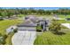 Beautiful home exterior with well-kept lawn, long driveway and three-car garage at 12637 Tyler Run Ave, Odessa, FL 33556