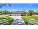 Charming home featuring a three-car garage, manicured lawn, and inviting driveway at 12637 Tyler Run Ave, Odessa, FL 33556