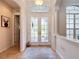 Light and bright foyer features neutral tile flooring, double entry doors and arched transom window at 12637 Tyler Run Ave, Odessa, FL 33556