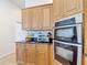 Kitchen with stainless steel appliances, including oven, microwave, and tile backsplash at 12637 Tyler Run Ave, Odessa, FL 33556