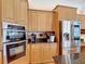 Spacious kitchen with stainless steel appliances and custom cabinets at 12637 Tyler Run Ave, Odessa, FL 33556