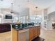 Spacious kitchen with breakfast bar island with stainless steel dishwasher and granite countertops at 12637 Tyler Run Ave, Odessa, FL 33556