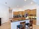 Open kitchen with breakfast bar island, stainless appliances and tile flooring at 12637 Tyler Run Ave, Odessa, FL 33556