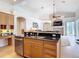 Kitchen island with stainless steel dishwasher, sink and granite countertops at 12637 Tyler Run Ave, Odessa, FL 33556