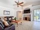 Large living room boasts vaulted ceilings, fireplace, ceiling fan, and a view of the lanai at 12637 Tyler Run Ave, Odessa, FL 33556