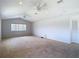 Bright living room with vaulted ceilings, carpet flooring, offering a comfortable and inviting space at 12637 Tyler Run Ave, Odessa, FL 33556