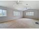 Spacious living room featuring vaulted ceilings with fans and multiple windows, offering natural light and views at 12637 Tyler Run Ave, Odessa, FL 33556