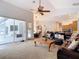 Open living room connects to kitchen and lanai, featuring a ceiling fan, and lots of space at 12637 Tyler Run Ave, Odessa, FL 33556