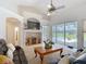 Spacious living room featuring high ceilings, fireplace, ceiling fan, and view of screened lanai at 12637 Tyler Run Ave, Odessa, FL 33556