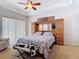 Comfortable main bedroom with carpet, ceiling fan, and built in storage and TV at 12637 Tyler Run Ave, Odessa, FL 33556