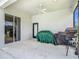 Covered patio with a ceiling fan, tile floor, and a door and sliding glass doors providing access to outdoors at 12637 Tyler Run Ave, Odessa, FL 33556