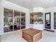Covered patio with tile flooring, sliding glass doors, and views of the screened-in pool and outdoor landscape at 12637 Tyler Run Ave, Odessa, FL 33556