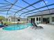 Screened-in pool and patio area featuring chaise lounges, lush potted plants, and backyard views at 12637 Tyler Run Ave, Odessa, FL 33556