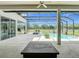 Outdoor pool area and patio featuring inviting lounge area surrounded by screened-in enclosure and garden views at 12637 Tyler Run Ave, Odessa, FL 33556