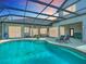 Relaxing screened-in pool area with lounge chairs, perfect for enjoying the outdoors in comfort at 12637 Tyler Run Ave, Odessa, FL 33556