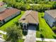 An aerial view shows the house and property with a view of green space in the neighborhood at 13113 Green Violet Dr, Riverview, FL 33579