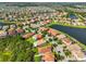 An aerial view of a residential area featuring a single-Gathering home amongst lush greenery and community amenities at 13113 Green Violet Dr, Riverview, FL 33579