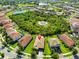 An aerial view highlights this home's location, surrounded by mature landscaping and a neighborhood lake at 13113 Green Violet Dr, Riverview, FL 33579