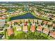 An aerial view of a residential area featuring a single-Gathering home amongst lush greenery and community amenities at 13113 Green Violet Dr, Riverview, FL 33579