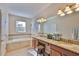 This primary bathroom has a soaking tub, double sinks and beautiful granite countertops at 13113 Green Violet Dr, Riverview, FL 33579