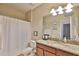 Bathroom with granite countertop vanity, framed mirror, and shower with curtain at 13113 Green Violet Dr, Riverview, FL 33579