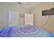 Comfortable bedroom featuring two doors and a television at 13113 Green Violet Dr, Riverview, FL 33579