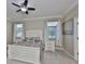 Comfortable bedroom with large windows, ceiling fan, and cozy decor at 13113 Green Violet Dr, Riverview, FL 33579