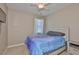 Comfortable bedroom featuring a ceiling fan, window, and bedside table at 13113 Green Violet Dr, Riverview, FL 33579