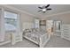 Bright bedroom boasts neutral colors, two windows, and an ensuite bathroom at 13113 Green Violet Dr, Riverview, FL 33579