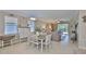 Bright dining area flows into the living room featuring stylish furnishings and tiled flooring at 13113 Green Violet Dr, Riverview, FL 33579