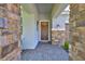 Inviting front entrance showcasing stone accents, a decorative wreath, and a brick-paved walkway at 13113 Green Violet Dr, Riverview, FL 33579