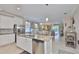Open-concept kitchen with stainless steel appliances, a large island, and views into the living and dining areas at 13113 Green Violet Dr, Riverview, FL 33579