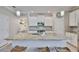 Granite island with a sink and seating provides a focal point in this bright, well-equipped kitchen at 13113 Green Violet Dr, Riverview, FL 33579
