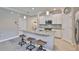 Open kitchen with a central island, stainless steel appliances, and casual seating for three at 13113 Green Violet Dr, Riverview, FL 33579