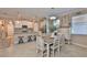 Bright and open kitchen flows into the dining area and features stainless steel appliances and an island with barstool seating at 13113 Green Violet Dr, Riverview, FL 33579