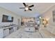Spacious living room blends into the kitchen featuring a ceiling fan and neutral paint at 13113 Green Violet Dr, Riverview, FL 33579