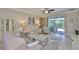 Comfortable living room features neutral tones, sliding glass doors to the patio, and stylish decor at 13113 Green Violet Dr, Riverview, FL 33579