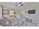 Main bedroom featuring an ensuite bath, a chest of drawers, and a mounted TV at 13113 Green Violet Dr, Riverview, FL 33579