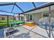 Relaxing screened-in patio with a hot tub, potting bench, and comfortable lounge seating at 13113 Green Violet Dr, Riverview, FL 33579