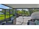 Relaxing screened patio with chairs, BBQ, and peaceful green backyard at 13113 Green Violet Dr, Riverview, FL 33579