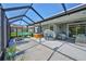 Spacious open-air patio with comfortable seating, hot tub, and outdoor kitchen at 13113 Green Violet Dr, Riverview, FL 33579