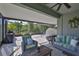 Outdoor patio featuring a grill, multiple seating areas, and a ceiling fan at 13113 Green Violet Dr, Riverview, FL 33579